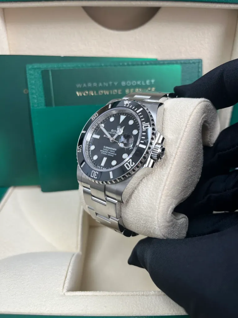 ROLEX SUBMARINER DATE BLACK DIAL STAINLESS STEEL RIGHT SIDE IN HAND PIC FOR MASTER.webp